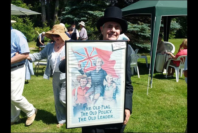 Sir John A. Macdonald holding the 1878 Election Poster